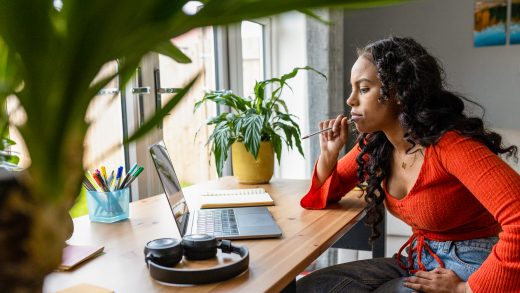 A woman using Surface laptop on a desk