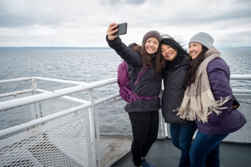 A family taking a selfie on a ferry
