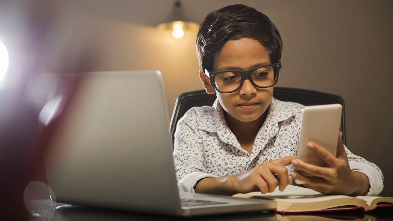 Photo of a young student taking a quiz on a laptop.