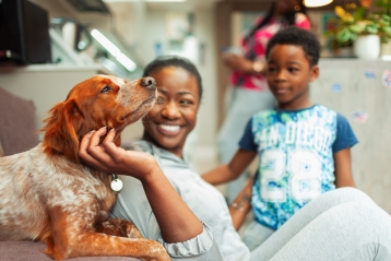 A smiling family with their dog