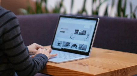 Decorative image of a Windows laptop with grayscale screen.